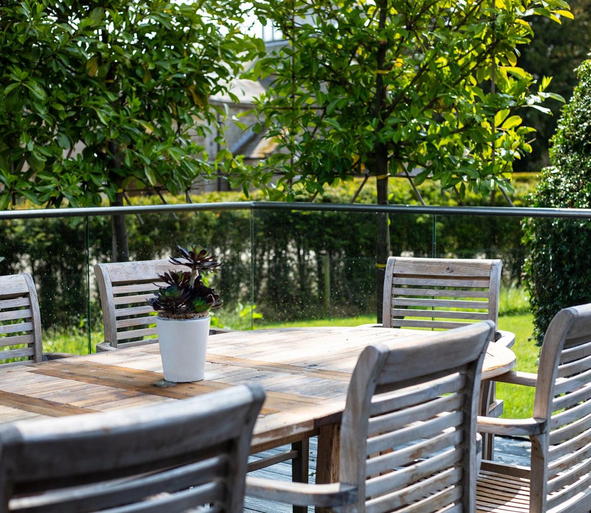 Patio table surrounded by lush trees