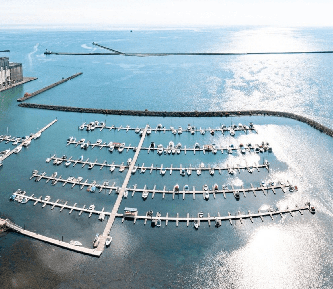 Marina with boats and calm blue water.